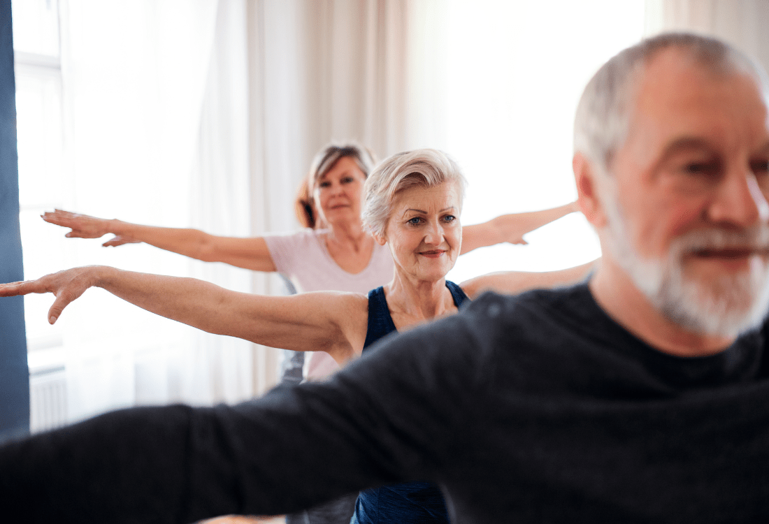 Group exercise class in a modern leisure centre, showcasing activities to promote health and wellbeing in an inclusive community setting.