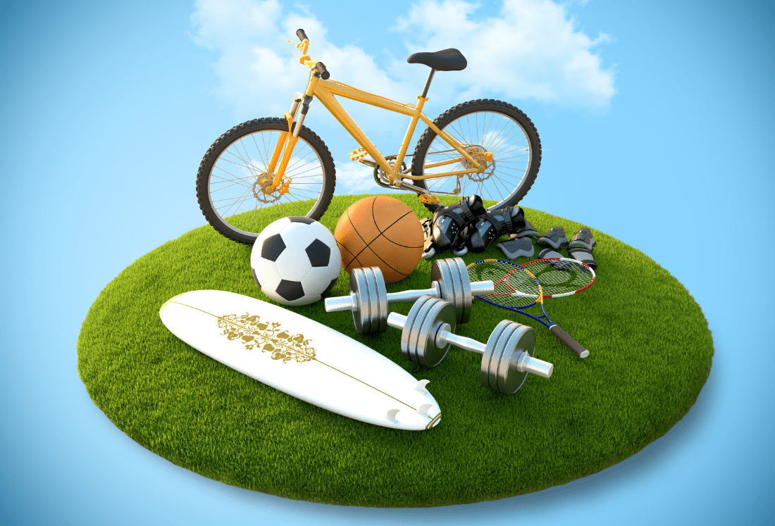 Collection of sports equipment on grass symbolising sustainable leisure facilities and multi-activity spaces that support long-term health, wellbeing, and energy-efficient facility planning.